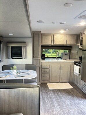 Microwave, dishwasher, coffee/tea maker, dining tables