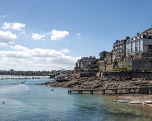 A coastal town with buildings along the waterfront, a pier, and boats. - Sessile oaks - PLESLIN TRIGAVOU (PLESLIN TRIGAVOU)