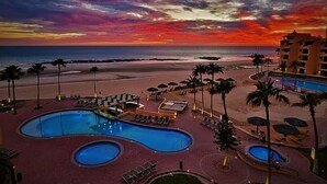 A resort with multiple swimming pools, beach access, and a view of the ocean at sunset. - Vibe by the Sea of Cortez @Princesa Resort (Puerto Peñasco, Son)