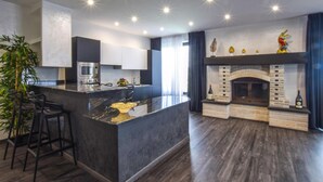 A modern kitchen with a central island, built-in oven, and microwave. - Lovely apartment in Palmi (Palmi)