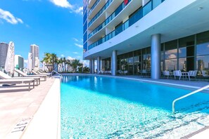 Relax by the pool with a view of the city skyline.