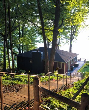 Escape to a serene natural haven with a deck and lush surroundings.