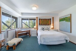 A bedroom with a bed, desk, chair, and a large window. - Tahoe Views & Tahoe Park Access (Tahoe City)