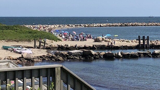 A beach with people, umbrellas, and boats. - Narragansett- 1 block to Narrow River! (Narragansett)