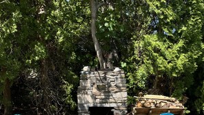 A stone fireplace with two blue Adirondack chairs in front. - Narragansett- 1 block to Narrow River! (Narragansett)
