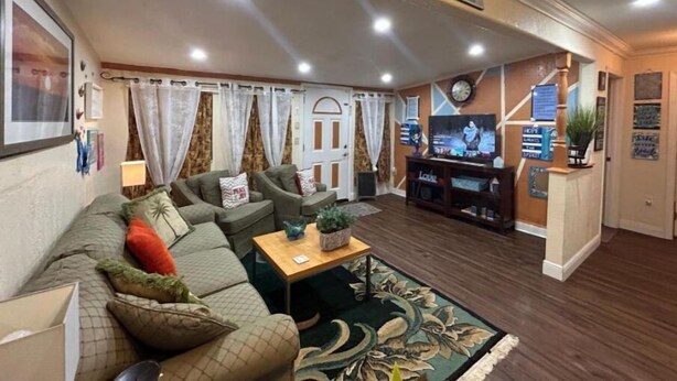 A cozy living room with a sectional sofa, a flat-screen TV, and a small coffee table. - Good Location / Good people AND GOOD VIBES ONLY  (Spring Hill)