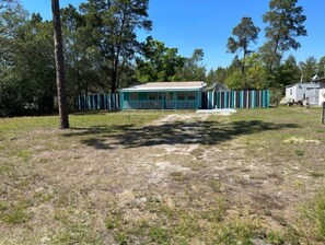 A single-story house with a blue exterior and a small porch. - Good Location / Good people AND GOOD VIBES ONLY  (Spring Hill)