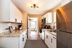 Enjoy cooking in this well-equipped kitchen with a granite countertop, microwave, and coffee maker.