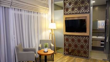 Deluxe Double or Twin Room, 1 Bedroom | Living area | 32-inch LED TV with cable channels, TV