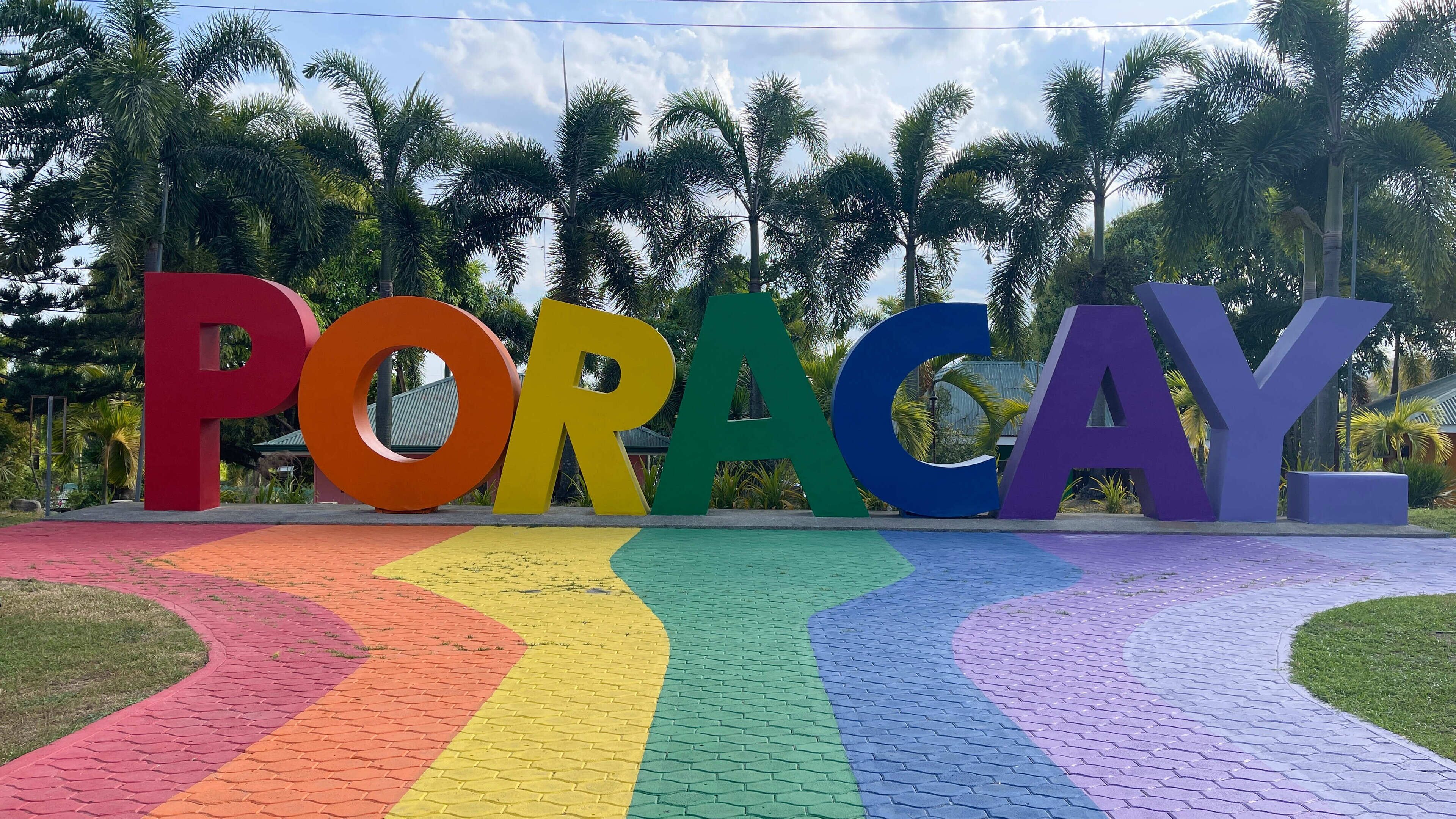 A colorful pathway leading to large letters spelling "PORACAY."