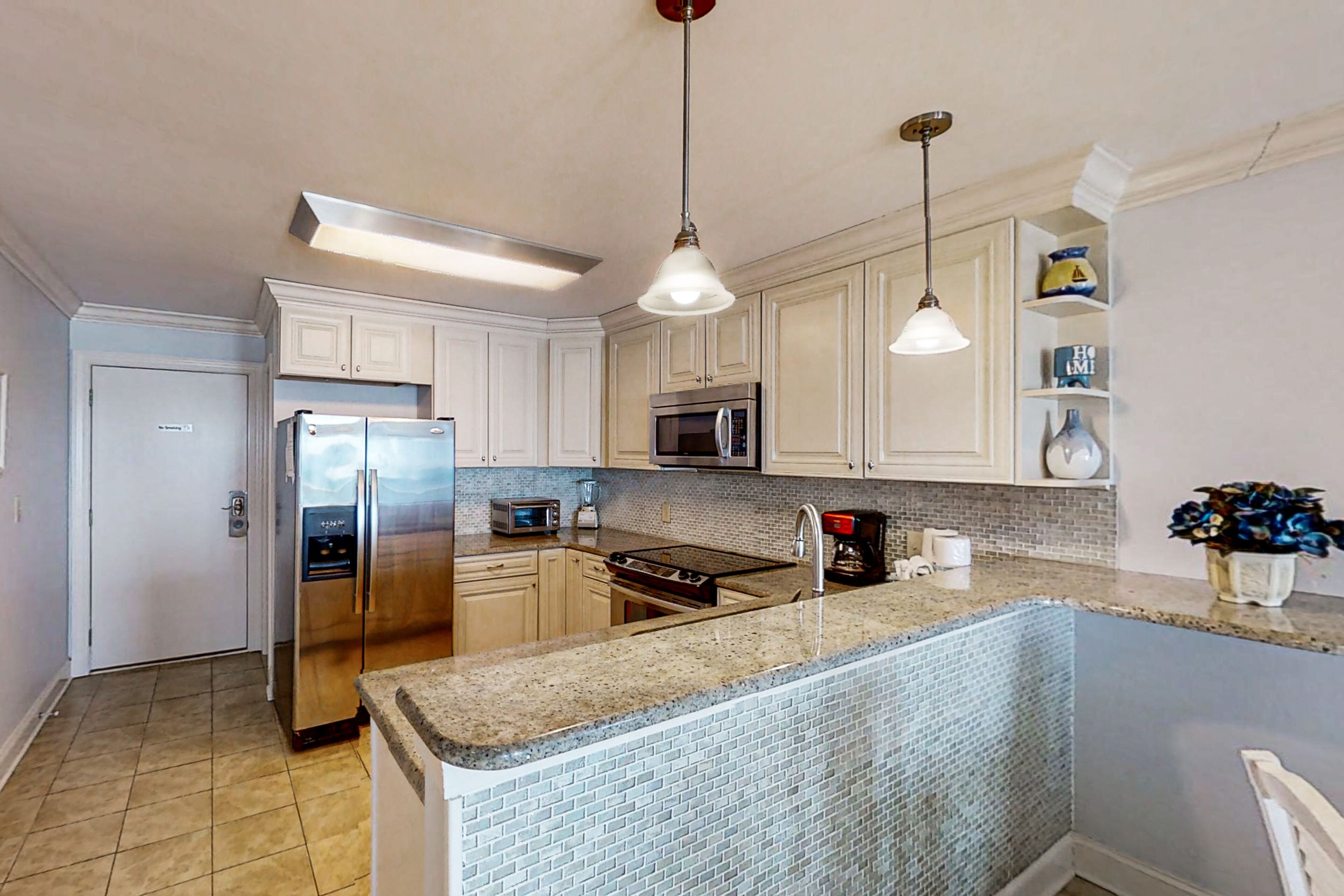 Oceanfront condo with balcony, beach view, pool access, & central AC