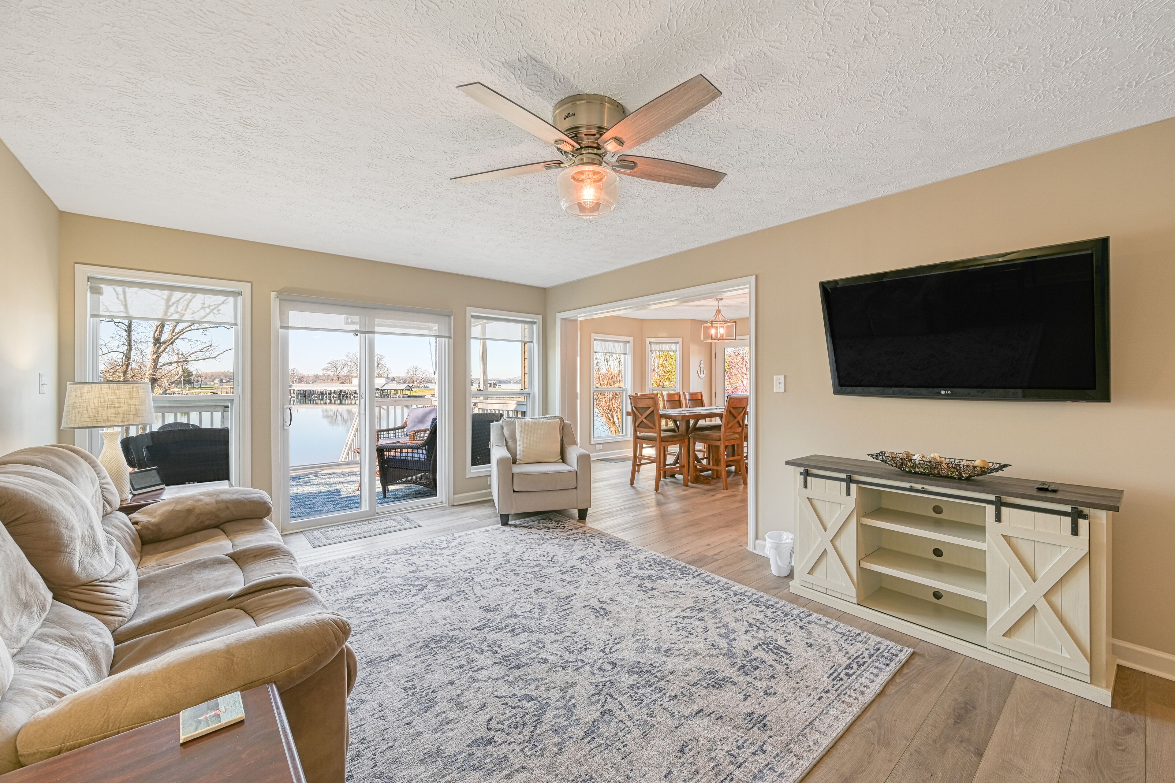 Serene lakefront home with dock, patio, grill, hot tub, pool table, & W/D