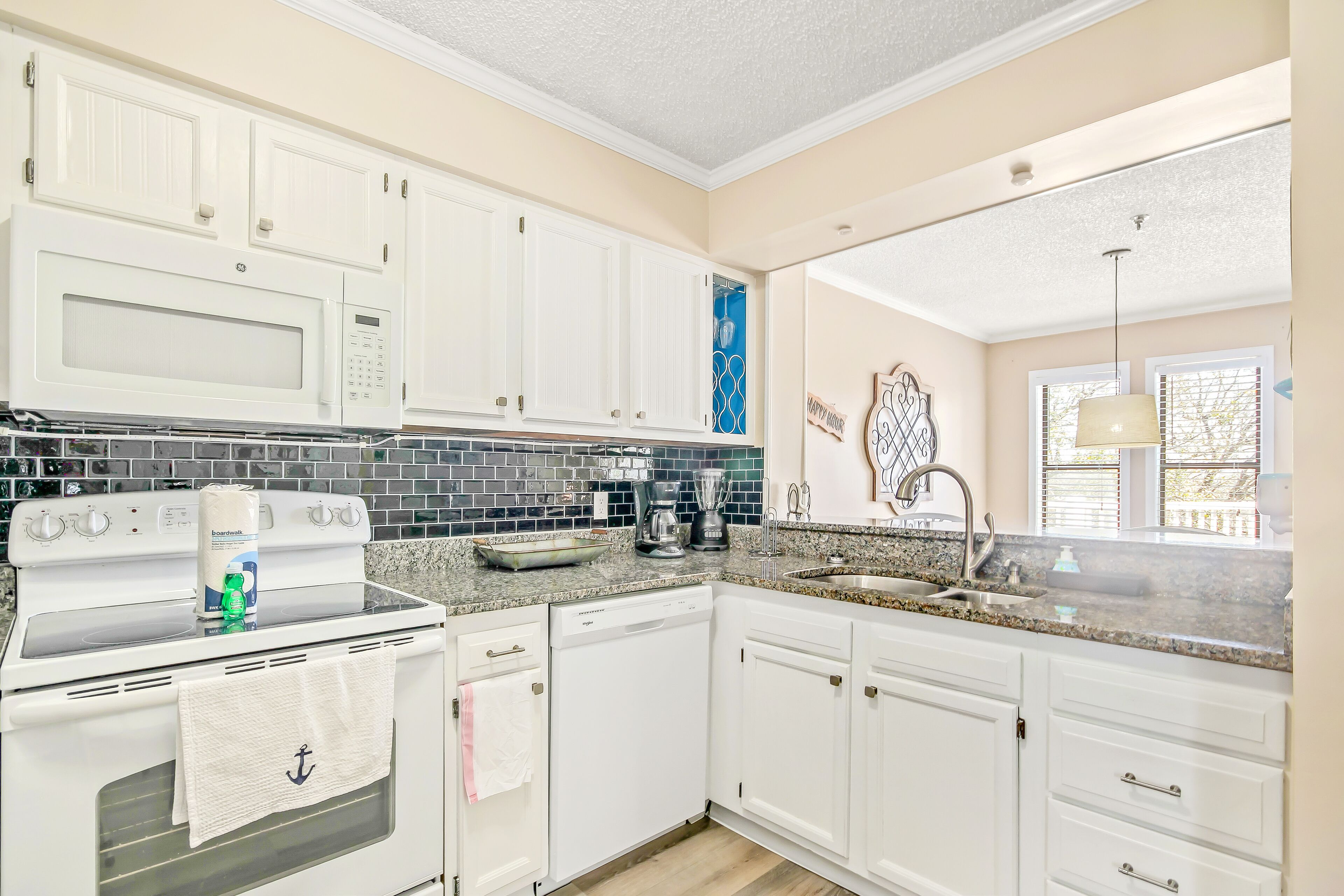 Updated dog-friendly condo with water views, pool, & deck