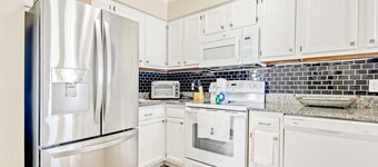 Updated condo with water views, pool, well-equipped kitchen, & deck