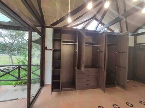 A room with a built-in wardrobe, a window, and a view of the outdoors. - Villa Nathalie, jaccuzzi, king size bed+hammock (Chican, Paute)