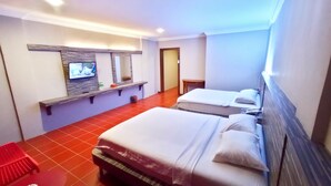A hotel room with two beds, a TV on a shelf, and a red chair. - Kita Hotel (Tanjung Pinang)