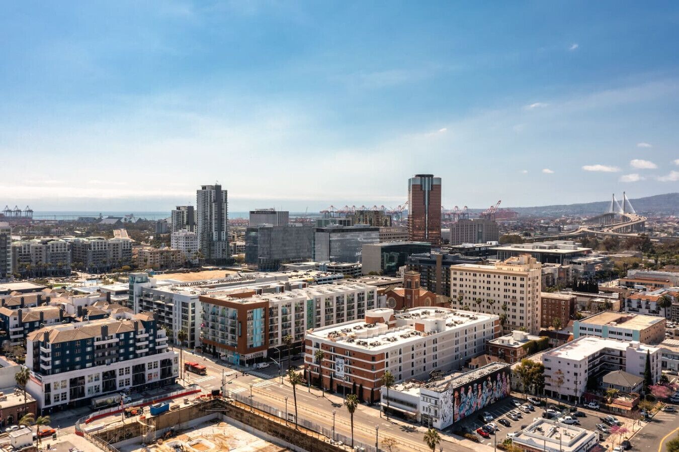 Un paisaje urbano con diversos edificios, incluyendo rascacielos y edificios de altura media, bajo un cielo despejado.