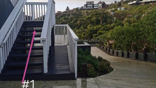 A modern staircase with white railings leading up to a building, surrounded by lush greenery and a hillside. - Penelope garden ,5 min to Botany shopping mall (Auckland)