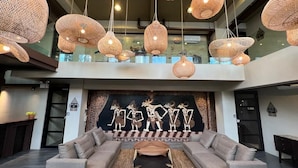 A modern lobby with a sofa, a coffee table, and a wall with a mural.
