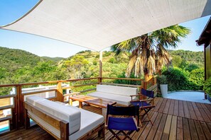An outdoor deck with wooden furniture, a canopy, and a view of a hilly landscape. - Club Villamar - Rent your dream villa and spend an unforgettable holiday (Calonge)