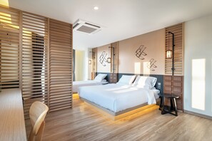 A modern bedroom with two beds, wooden slat partitions, and a small table. - Phra Nakhon Poshtel (Bangkok)