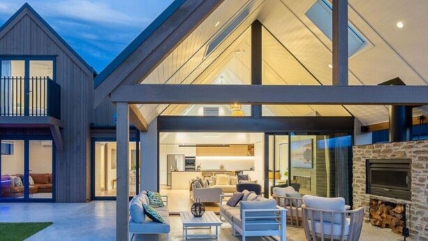 A modern house with a spacious outdoor living area, including a fireplace and comfortable seating. - Miharo Wanaka Retreat | Spa, BBQ & Mountain Views (Wānaka)