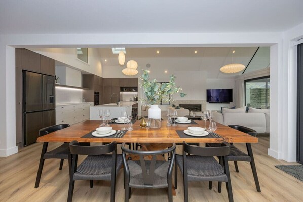 A modern kitchen with a dining area.