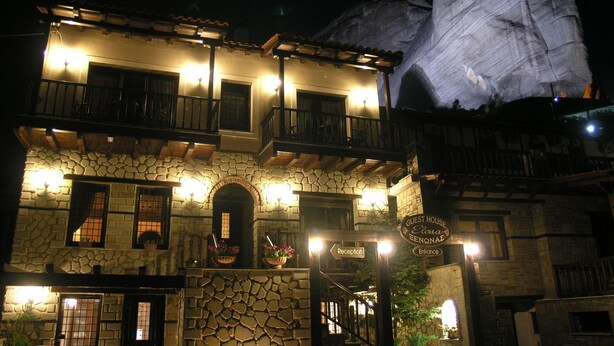 A stone building with a reception area and a sign indicating a guest house named Elena Benonaz. - Guesthouse Elena (Kalabaka)