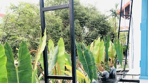 A balcony with potted plants and a metal railing. - An's family homestay (Da Nang)