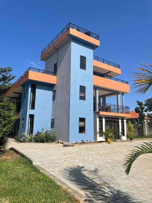 Stylish building with a unique architectural design, featuring balconies and a covered entrance area.