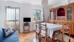 A room with a dining table, chairs, a television, and a sofa. - Holiday Home 'Da Chicca' with Countryside View, Wi-Fi & Air Conditioning (Bolano)