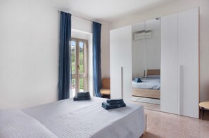 A bedroom with a bed, a chair, a wardrobe, and a window with curtains. - Holiday Home 'Da Chicca' with Countryside View, Wi-Fi and Air Conditioning (Bolano)