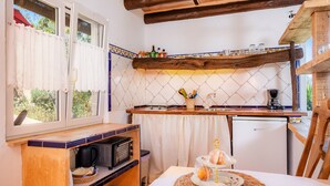 A compact kitchen with a microwave, coffee maker, and a small refrigerator. - Vacation Apartment "Individual Guesthouse Mallorca" with Mountain Views, Pool & Wi-Fi (Manacor)
