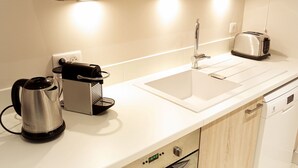A modern kitchen with a stainless steel kettle, a coffee maker, a toaster, and a dishwasher. - Condillac - Localisation exceptionnelle avec ascen (Burdeos)