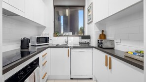 Fridge, microwave, oven, stovetop - Beachfront 2 bedroom apartment, air conditioning + balcony (Alexandra Headland)