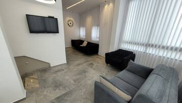 Basic Apartment | Living area | 34-inch LCD TV with cable channels, TV