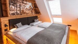 Een slaapkamer met een groot bed, een houten hoofdbord en een muurschildering.