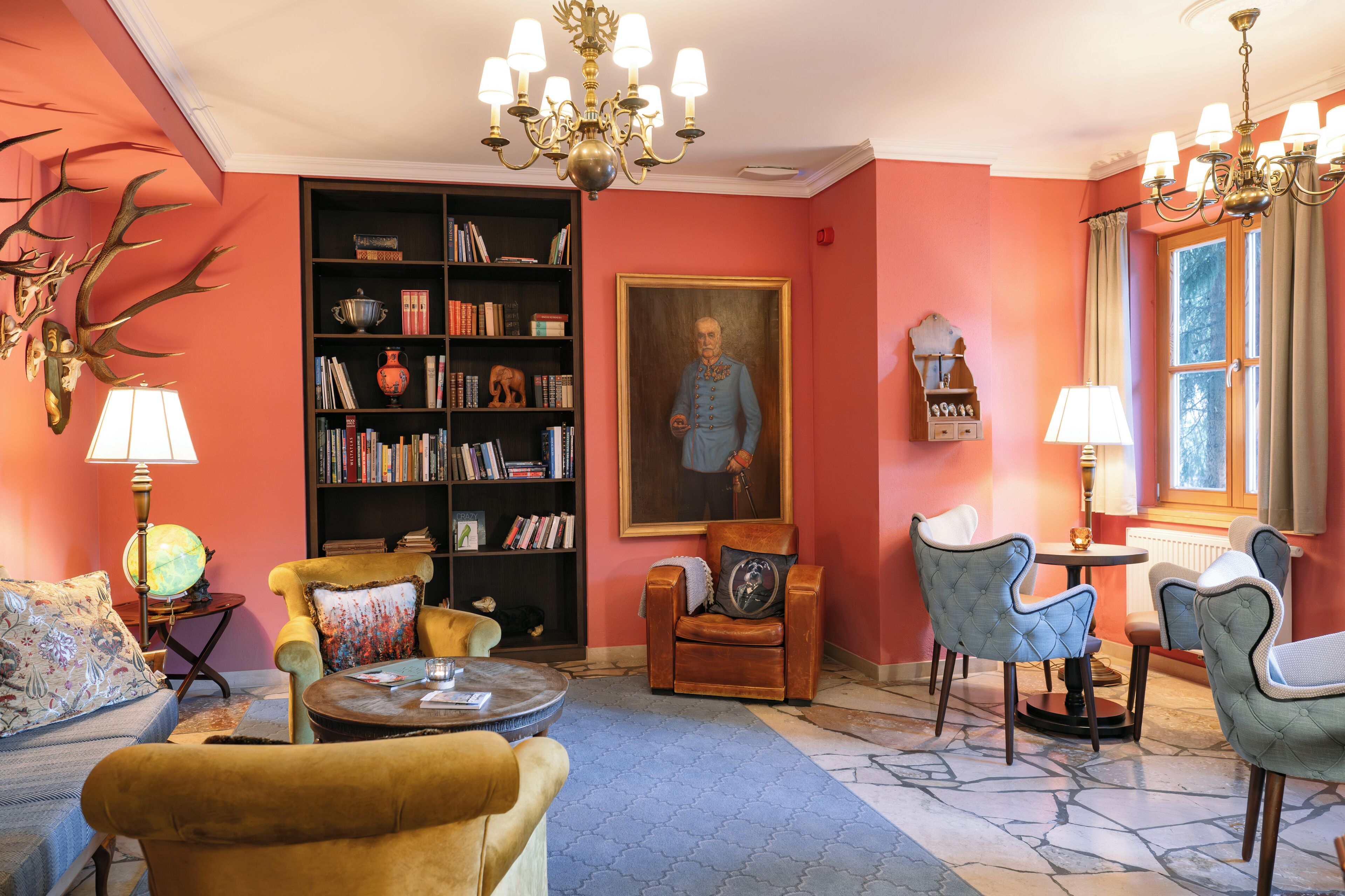 A cozy living room with a fireplace, a bookshelf, and comfortable seating.