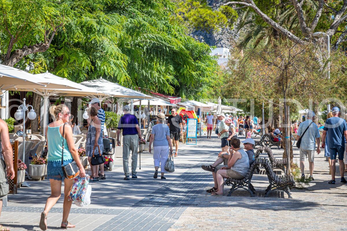 A bustling outdoor market with vendors and shoppers.