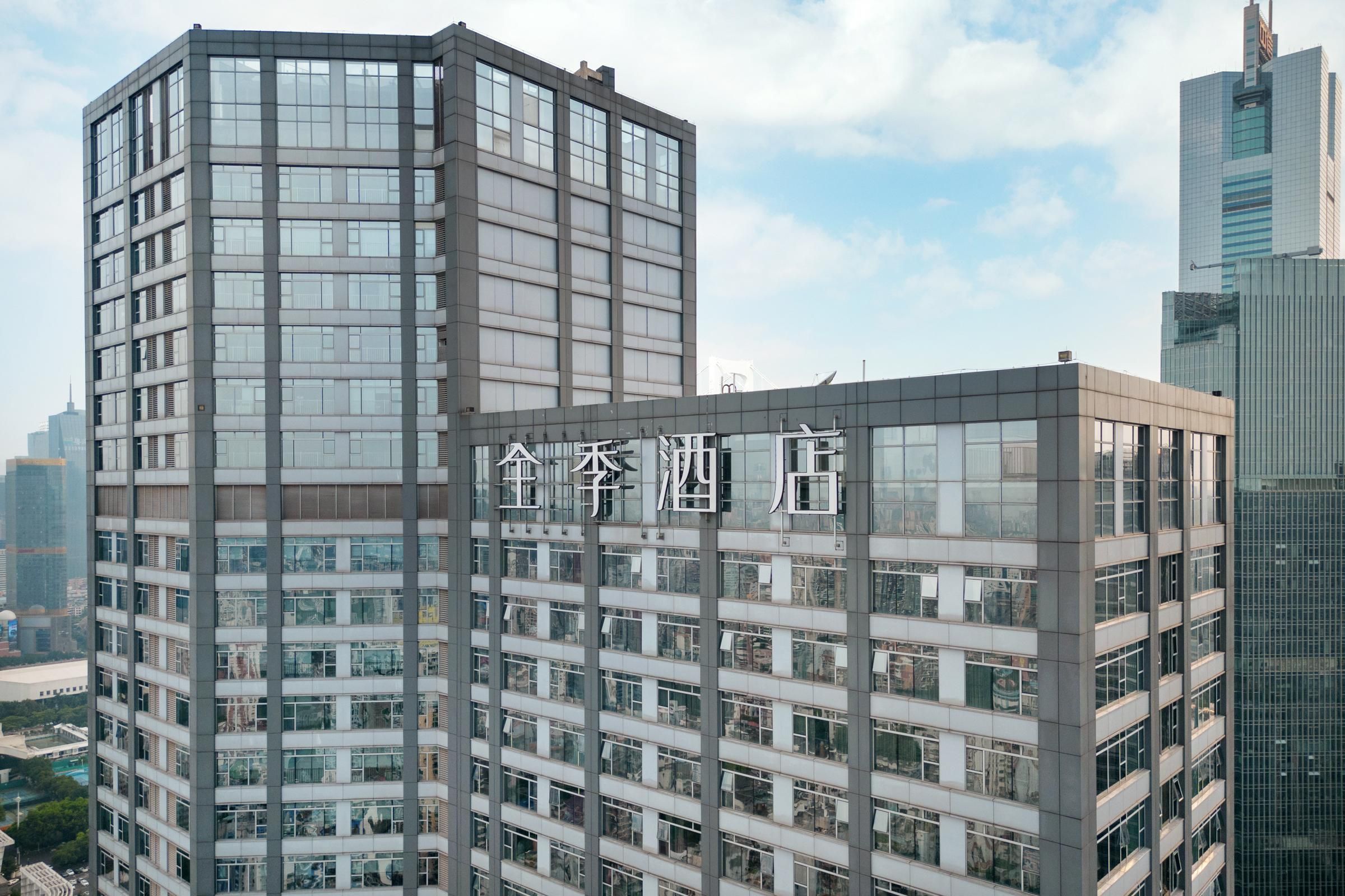 A modern high-rise building with multiple floors and large windows.