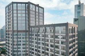 A modern high-rise building with multiple floors and large windows. - Ji Hotel Guangzhou Tianhe Sports Center (Guangzhou)