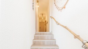 A staircase with wooden steps leading to an interior space. - Casa Do by Interhome (Roses)