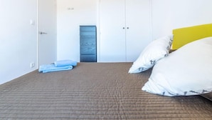 A bedroom with a bed, a wardrobe, and a door. - Prisange by Interhome (Roses)