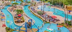 A water park with multiple swimming pools, slides, and a wave machine.