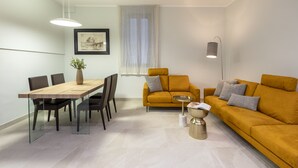 Ein modernes Wohnzimmer mit einem Holzesstisch, einer Couch und einem Couchtisch.