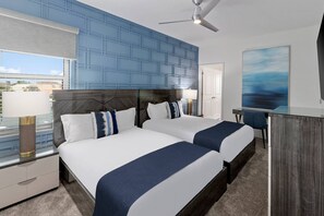 A hotel room with two beds, a desk, a chair, a ceiling fan, and a large window with a view. - Mermaid Magic | New Beach Home w Sea Themed BR, Pool, Theater, Arcade, Game Rm (Melbourne Beach)