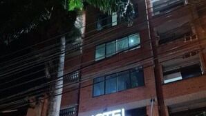 A hotel with a prominent "HOTEL" sign and a "HOTEL SURAMERICANA" sign. - HOTEL SURAMERICANA (Medellín)