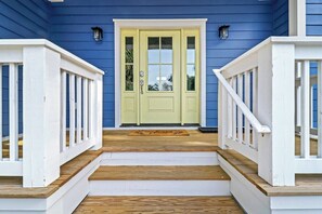 Stunning two-story house with a welcoming front porch and a beautifully painted exterior.