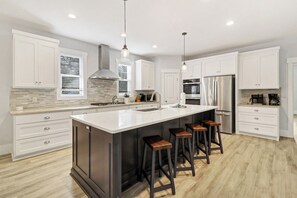 Enjoy cooking in this well-equipped kitchen with a large island and bar stools.
