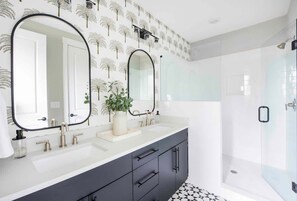 Bathtub, hair dryer, towels, shampoo